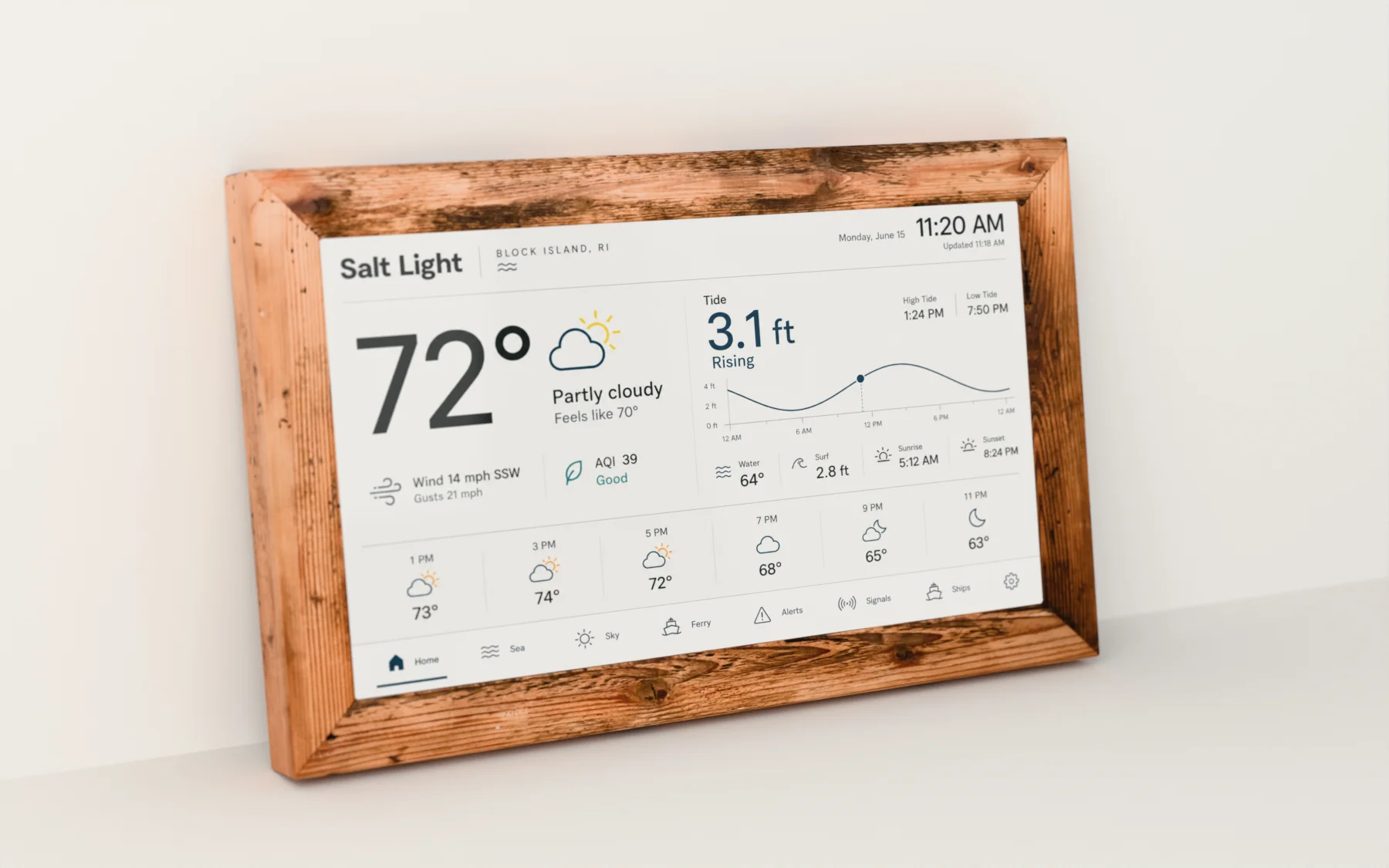 The Salt Light Instrument in its reclaimed-pine frame, showing the Home screen: temperature, air quality, the day's tide curve and the next hours.